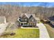 An aerial view of a well-maintained home with a large yard surrounded by mature trees at 5977 Wildcreek Rd, Sugar Hill, GA 30518
