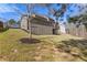 Spacious sloping backyard featuring a house with a deck and ample outdoor space for recreation and relaxation at 5977 Wildcreek Rd, Sugar Hill, GA 30518