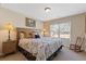 Light-filled bedroom showcasing a large bed, wooden accents, and cozy decor at 5977 Wildcreek Rd, Sugar Hill, GA 30518