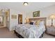 Bright bedroom with a full bed, side table, and a bathroom view at 5977 Wildcreek Rd, Sugar Hill, GA 30518
