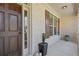 Up close view of a lovely brown front door with white brick surround and a dark brown shuttered window at 5977 Wildcreek Rd, Sugar Hill, GA 30518