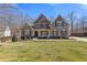 Charming two-story home featuring a well-manicured lawn and inviting front porch at 5977 Wildcreek Rd, Sugar Hill, GA 30518
