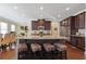 Kitchen island featuring granite countertops, stainless steel appliances, and barstool seating at 5977 Wildcreek Rd, Sugar Hill, GA 30518