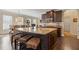 Spacious kitchen island with granite countertops and seating for four at 5977 Wildcreek Rd, Sugar Hill, GA 30518