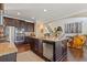 Gourmet kitchen island with granite counters, stainless appliances, and hardwood floors at 5977 Wildcreek Rd, Sugar Hill, GA 30518