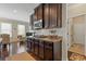 Well-equipped kitchen featuring granite countertops and dark wood cabinetry with stainless steel appliances at 5977 Wildcreek Rd, Sugar Hill, GA 30518