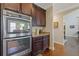Modern kitchen featuring stainless steel double ovens and custom cabinetry at 5977 Wildcreek Rd, Sugar Hill, GA 30518