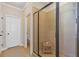 Modern tiled shower with frameless glass door and built-in bench at 5977 Wildcreek Rd, Sugar Hill, GA 30518