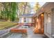 Backyard patio with a brick wall and outdoor seating with trees in the background at 1893 Windsor Sw Dr, Atlanta, GA 30311