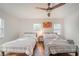 Bright bedroom features hardwood floors, ceiling fan and two twin beds with decorative accents at 1893 Windsor Sw Dr, Atlanta, GA 30311