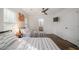 Bright bedroom with twin beds, hardwood floors, ceiling fan, and a mounted TV at 1893 Windsor Sw Dr, Atlanta, GA 30311