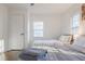Bright bedroom with two twin beds, white walls, a door, and natural light coming through the windows at 1893 Windsor Sw Dr, Atlanta, GA 30311