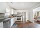 Modern kitchen with stainless steel appliances, white cabinetry, and a hardwood floor at 1893 Windsor Sw Dr, Atlanta, GA 30311