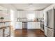 Bright kitchen with stainless steel appliances, white cabinetry, a breakfast bar, and elegant hardwood floors at 1893 Windsor Sw Dr, Atlanta, GA 30311