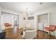 Bright living room with statement lighting, modern chairs, and a convenient laundry closet at 1893 Windsor Sw Dr, Atlanta, GA 30311
