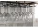 Wine glasses hanging upside down from a mounted rack in a kitchen, providing convenient and stylish storage at 1893 Windsor Sw Dr, Atlanta, GA 30311