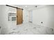 Spacious basement area featuring modern flooring and barn door at 681 Fielding Sw Ln, Atlanta, GA 30311