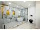 Luxurious bathroom with glass enclosed shower and tub, marble tile, and gold fixtures at 681 Fielding Sw Ln, Atlanta, GA 30311