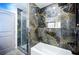 Elegant bathroom with marble tile, shower and tub at 681 Fielding Sw Ln, Atlanta, GA 30311