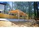 New modern carport built for sheltering two vehicles with surrounding greenery at 681 Fielding Sw Ln, Atlanta, GA 30311