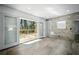 Bright living room with access to an outdoor deck, featuring modern tile flooring and large glass sliding doors at 681 Fielding Sw Ln, Atlanta, GA 30311