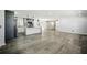 Open-concept living space connecting a modern kitchen to a large living area with stylish tile flooring at 681 Fielding Sw Ln, Atlanta, GA 30311