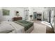 Bright main bedroom with ensuite bathroom, barn door, light wood floors, and natural light at 681 Fielding Sw Ln, Atlanta, GA 30311