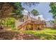 A wooden deck attached to the rear of a home, with a wooded backdrop at 119 Creekside Vw, Hiram, GA 30141
