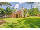 Spacious backyard with a large deck, lush green lawn, and mature trees at 119 Creekside Vw, Hiram, GA 30141