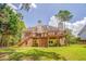 Backyard view of a two-story home with a wooden deck and a well-maintained lawn at 119 Creekside Vw, Hiram, GA 30141