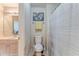 Well-lit bathroom showcasing a toilet, shower with curtain, and light wood vanity at 119 Creekside Vw, Hiram, GA 30141