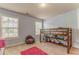 Bedroom with wooden bunk bed, a bean bag chair, and natural light at 119 Creekside Vw, Hiram, GA 30141