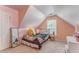 Cozy bedroom with a sloped ceiling, stuffed animals, and natural light from the window at 119 Creekside Vw, Hiram, GA 30141