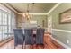 Elegant dining room with hardwood floors, decorative chandelier and wainscoting is perfect for entertaining at 119 Creekside Vw, Hiram, GA 30141