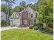 Beautiful two-story home with stone facade, lush lawn, mature trees, and attached two car garage at 119 Creekside Vw, Hiram, GA 30141