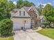 Inviting home with a landscaped yard, stone details, two-car garage, and a driveway basketball hoop at 119 Creekside Vw, Hiram, GA 30141