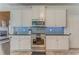 Stylish kitchen with stainless steel appliances, tile backsplash, and custom cabinets at 119 Creekside Vw, Hiram, GA 30141