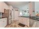 Bright kitchen with stainless appliances, modern cabinets, and stone tile floor at 119 Creekside Vw, Hiram, GA 30141