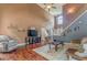 Cozy living room with high ceilings, hardwood floors, and open staircase at 119 Creekside Vw, Hiram, GA 30141
