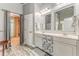 Well-lit main bathroom offering double sinks with decorative vanity and open doorway to walk-in closet at 119 Creekside Vw, Hiram, GA 30141
