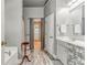 Bright bathroom with double sinks, decorative cabinets, standing stool and partial view of the walk-in closet at 119 Creekside Vw, Hiram, GA 30141