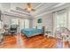 Large main bedroom with hardwood floors, tray ceiling, and ceiling fan; perfect for relaxing and unwinding at 119 Creekside Vw, Hiram, GA 30141
