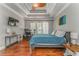 Spacious main bedroom with tray ceiling, ceiling fan, hardwood floors, and large windows at 119 Creekside Vw, Hiram, GA 30141