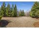 Expansive backyard is surrounded by mature trees, offering privacy and a natural setting at 2564 Lulworth Ne Ln, Marietta, GA 30062