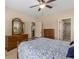 Bedroom featuring a ceiling fan, two dressers, a bed, and an adjoining closet at 2564 Lulworth Ne Ln, Marietta, GA 30062