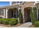 Close-up view of home's stone-accented entrance featuring manicured bushes, brickwork, and arched entryway at 2564 Lulworth Ne Ln, Marietta, GA 30062
