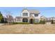 Charming two-story home featuring manicured landscaping, a stone-accented entrance, and neutral siding at 2564 Lulworth Ne Ln, Marietta, GA 30062