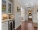 Elegant hallway features a built-in wine fridge, hardwood floors, and wainscoting at 2564 Lulworth Ne Ln, Marietta, GA 30062