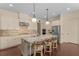 Bright kitchen boasts granite countertops, stainless steel appliances and pendant lighting at 2564 Lulworth Ne Ln, Marietta, GA 30062