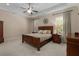 Relaxing main bedroom with tray ceiling, ceiling fan and neutral color palette at 2564 Lulworth Ne Ln, Marietta, GA 30062